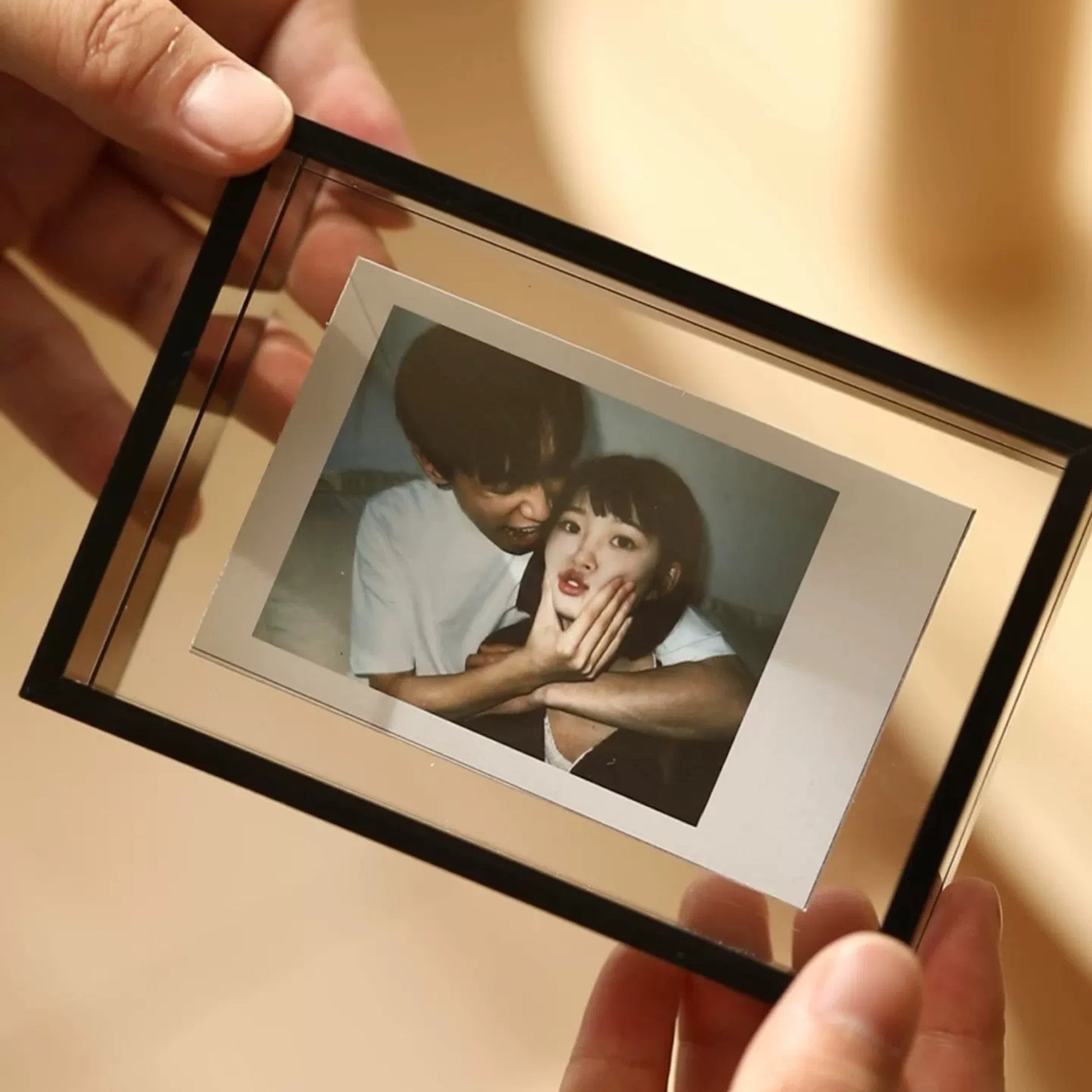 Close-up of the clear acrylic floating frame showing a photo between two panes