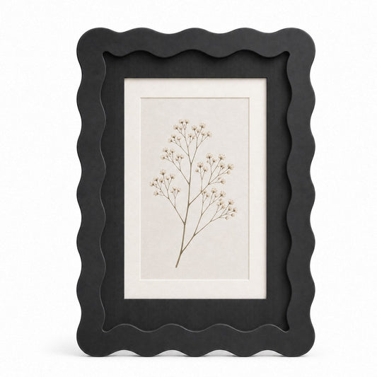 Black wavy-edge glass photo frame with botanical art insert on white background